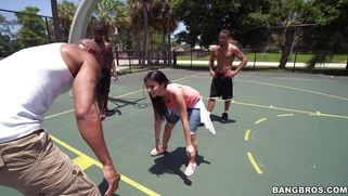Michelle Martinez playing basketball with three black muscle dudes
