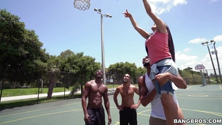 Michelle Martinez playing basketball with three black muscle dudes